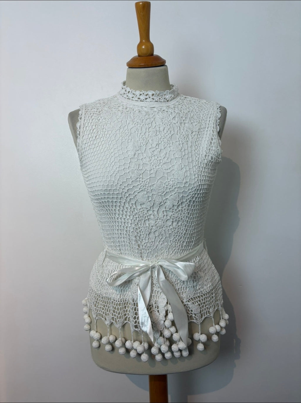 Handmade white crochet tie-up sleeveless top with tassel pom-poms