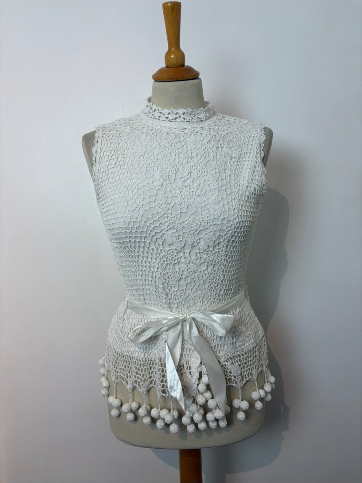 Handmade white crochet tie-up sleeveless top with tassel pom-poms