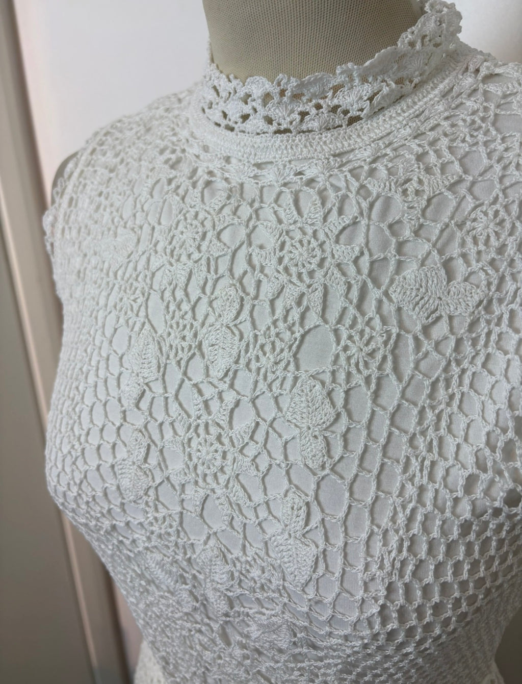 Handmade white crochet tie-up sleeveless top with tassel pom-poms