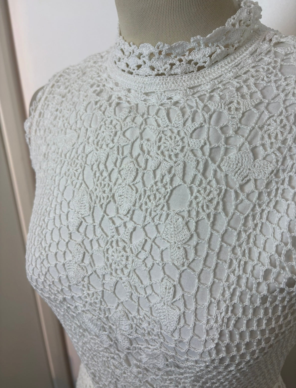 Handmade white crochet tie-up sleeveless top with tassel pom-poms