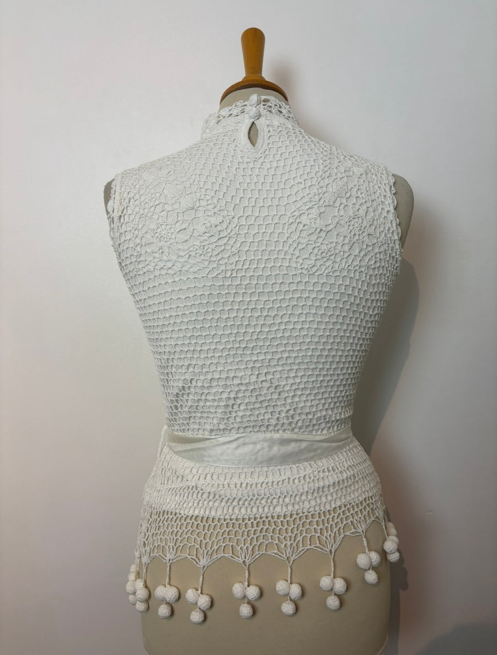 Handmade white crochet tie-up sleeveless top with tassel pom-poms