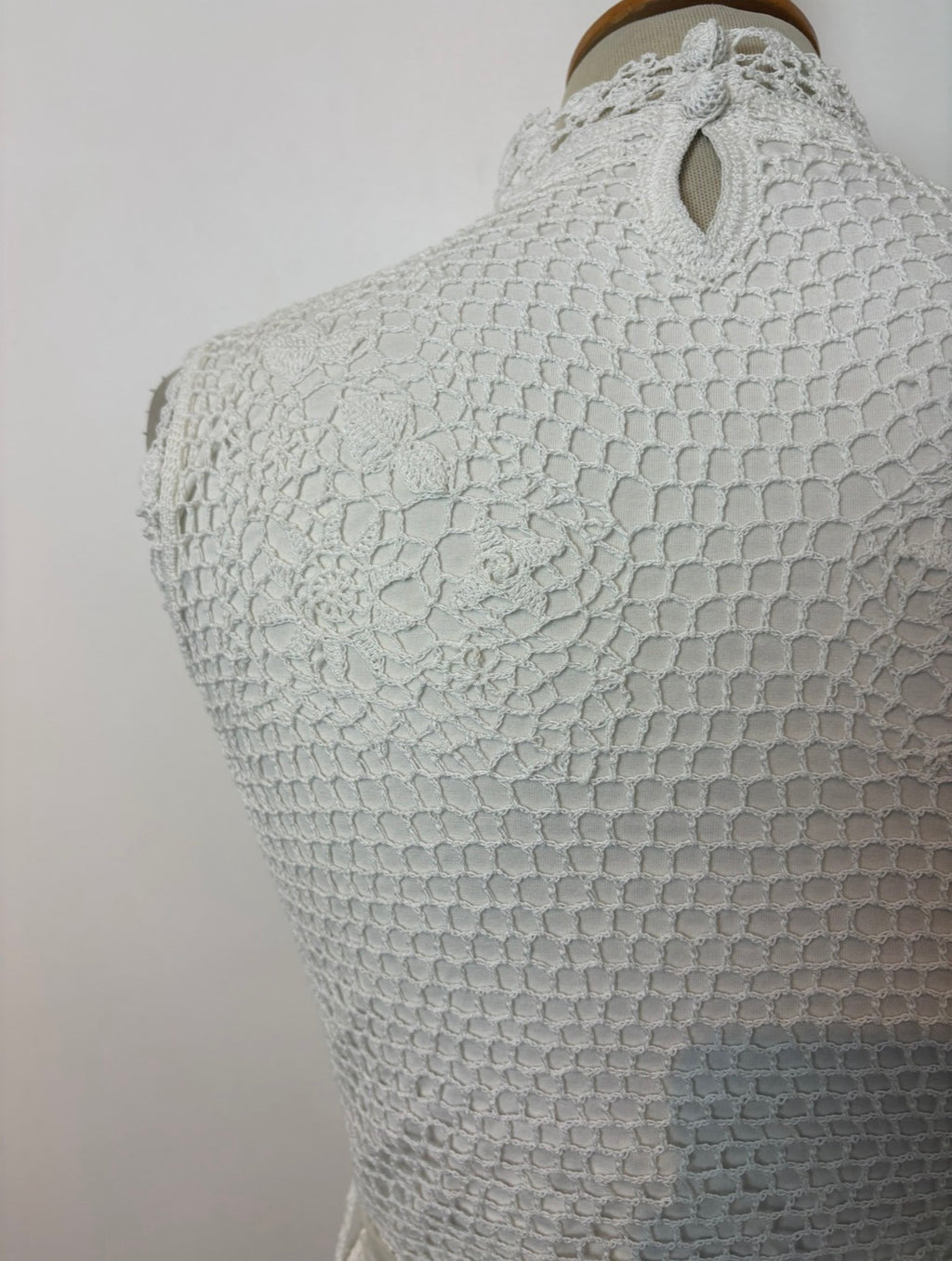 Handmade white crochet tie-up sleeveless top with tassel pom-poms